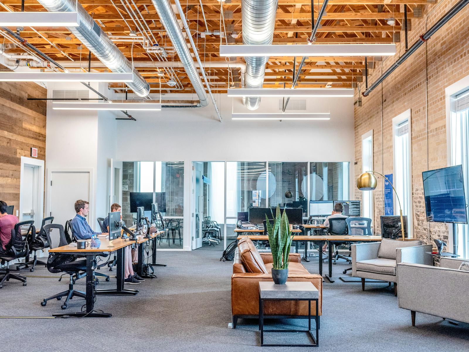 An open office with people working at computer desks.